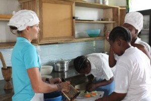 Opportunity-US staff member Abbi with the girls in the kitchen.
