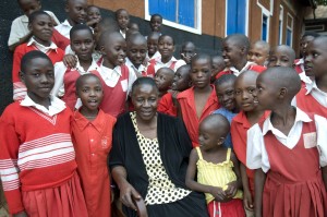 School proprietor and client Rosemary Namande, with students of the Nadulu Infant Primary School in Kampala.