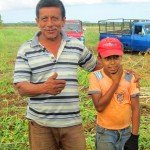 Client Eduardo Chavarria and his grandson, who loves to help out in the yucca fields after school, in Granada, Nicaragua.
