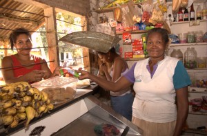 Client Argelia Ramirez (right), a shop owner in Henequen, Colombia, now has a safe place to save.  