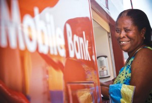 Beatrice Boaten accesses her savings account at a mobile bank.