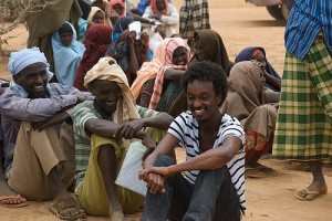 Musician K’naan with refugees waiting for tents.