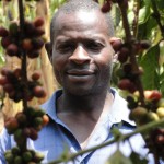 Mubende coffee farmer Rapheal Kulumba with coffee cherries.