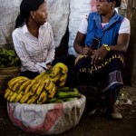 Tanzania: Sephina Macha, an Opportunity International client on her third loan cycle, talks to her loan officer Mary Jacobs next to her stand in the Arusha wholesale market where she sells bananas.