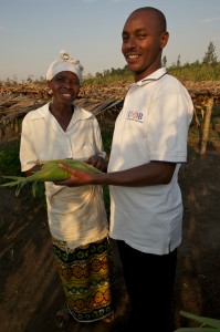 Transformational impact manager Daniel Ryumugabe meets with farming client Felicite Mukandahiro in Kibungo, Rwanda.