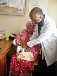 Theresia John Kombe’s daughter Loreen receives healthcare from Dr. Felix Lyimo in Pangara, Tanzania. As a coffeegrower with the Kilimanjaro Native Cooperative Union (KNCU), Theresia joined a MicroEnsure health plan connected to a network of clinics and pays one low annual premium to cover her whole family.