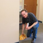 SVP Dennis cleans the church hallway.