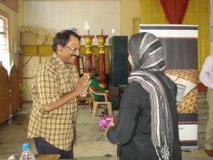 CEO Sam Chandar (left) visits with a client (June 2012).