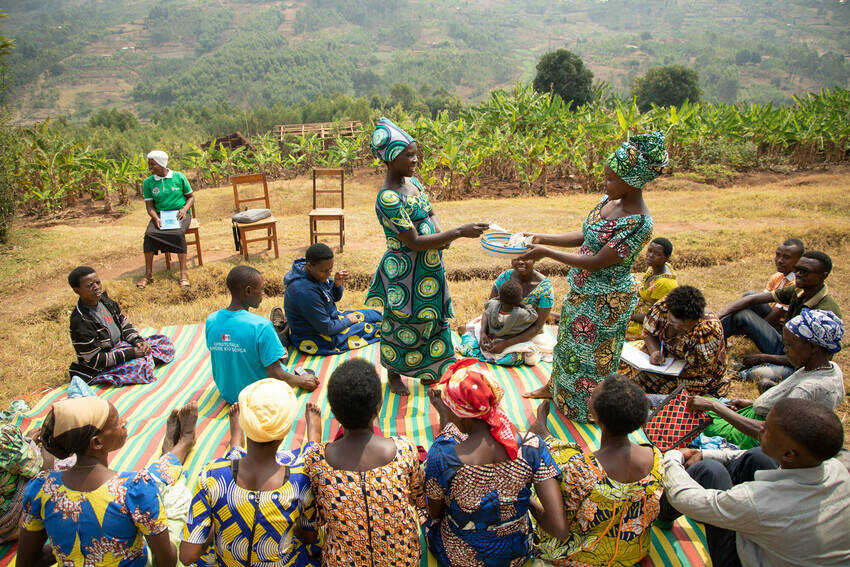 Felicia (standing, right), farmer and president of her savings group, Rwanda 